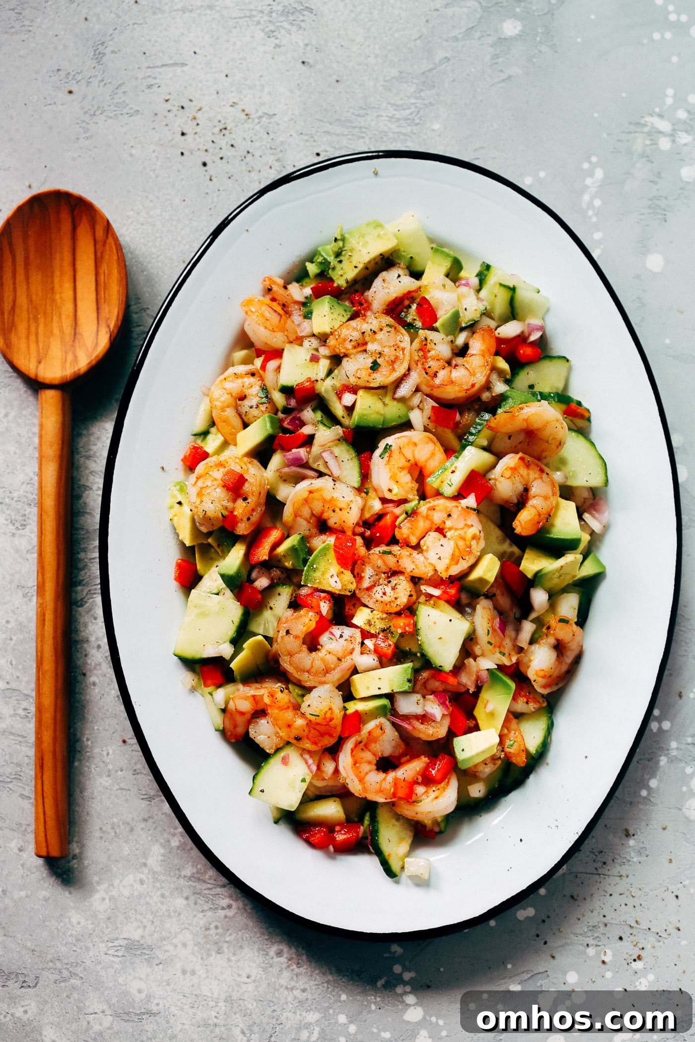  An oval serving platter container shrimp avocado cucumber salad 