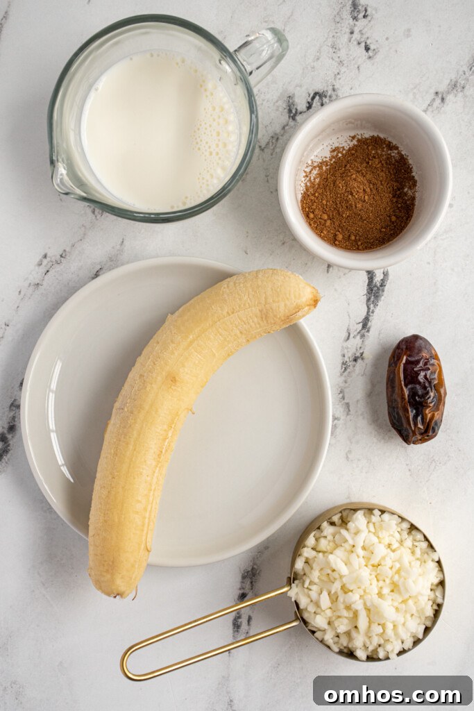 Ingredients needed to make a banana chai smoothie laid out on a table top.