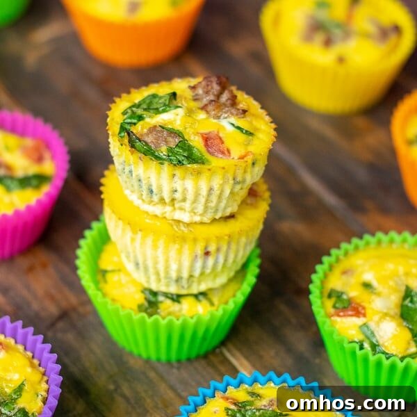 A stack of fresh cooked spinach sausage egg muffins