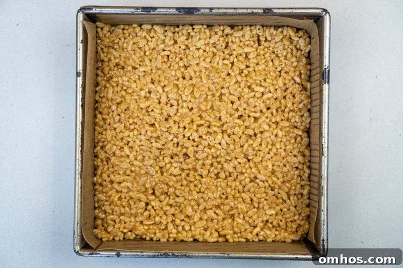 Spreading the puffed rice to the baking dish