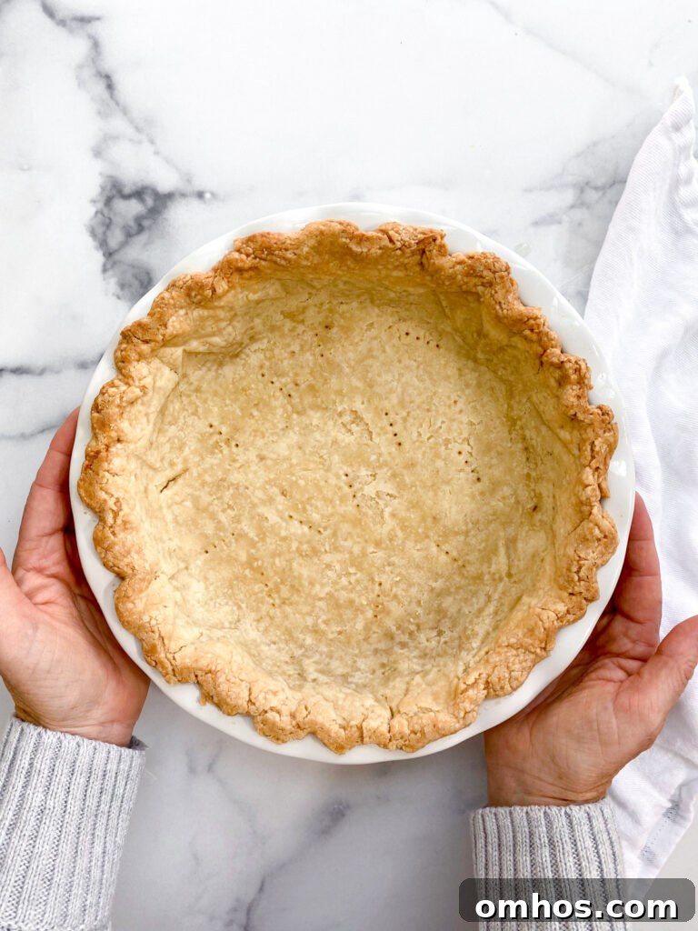 How to Make a Flaky, Buttery Pie Crust 2 hands holding the perfect flaky pie crust