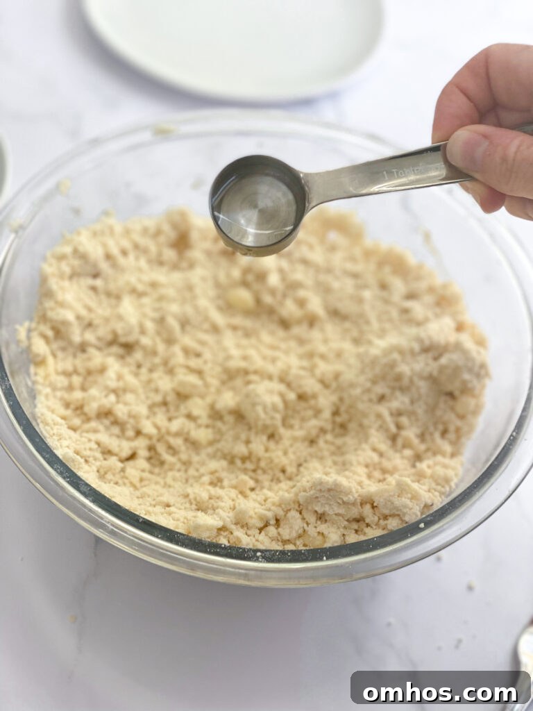 How to Make a Flaky, Buttery Pie Crust 5 adding water to dough