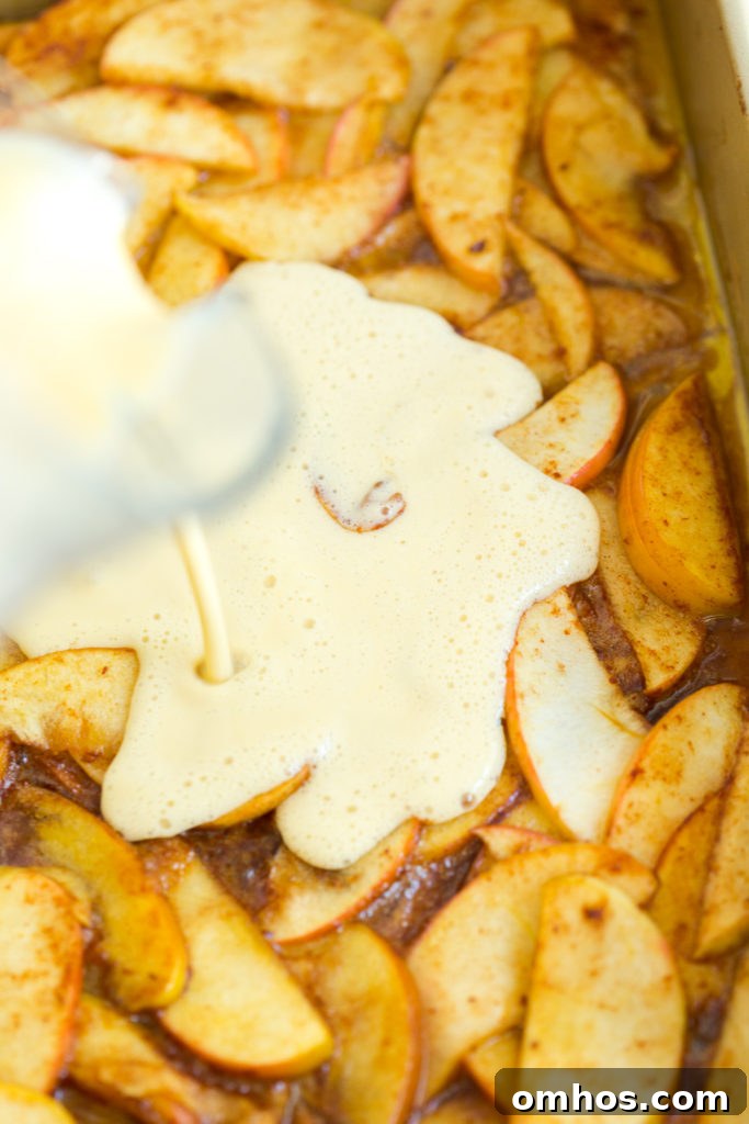 Hootenanny Apple-Bottom Pancake Recipe 7 Pouring the pancake batter over the apples