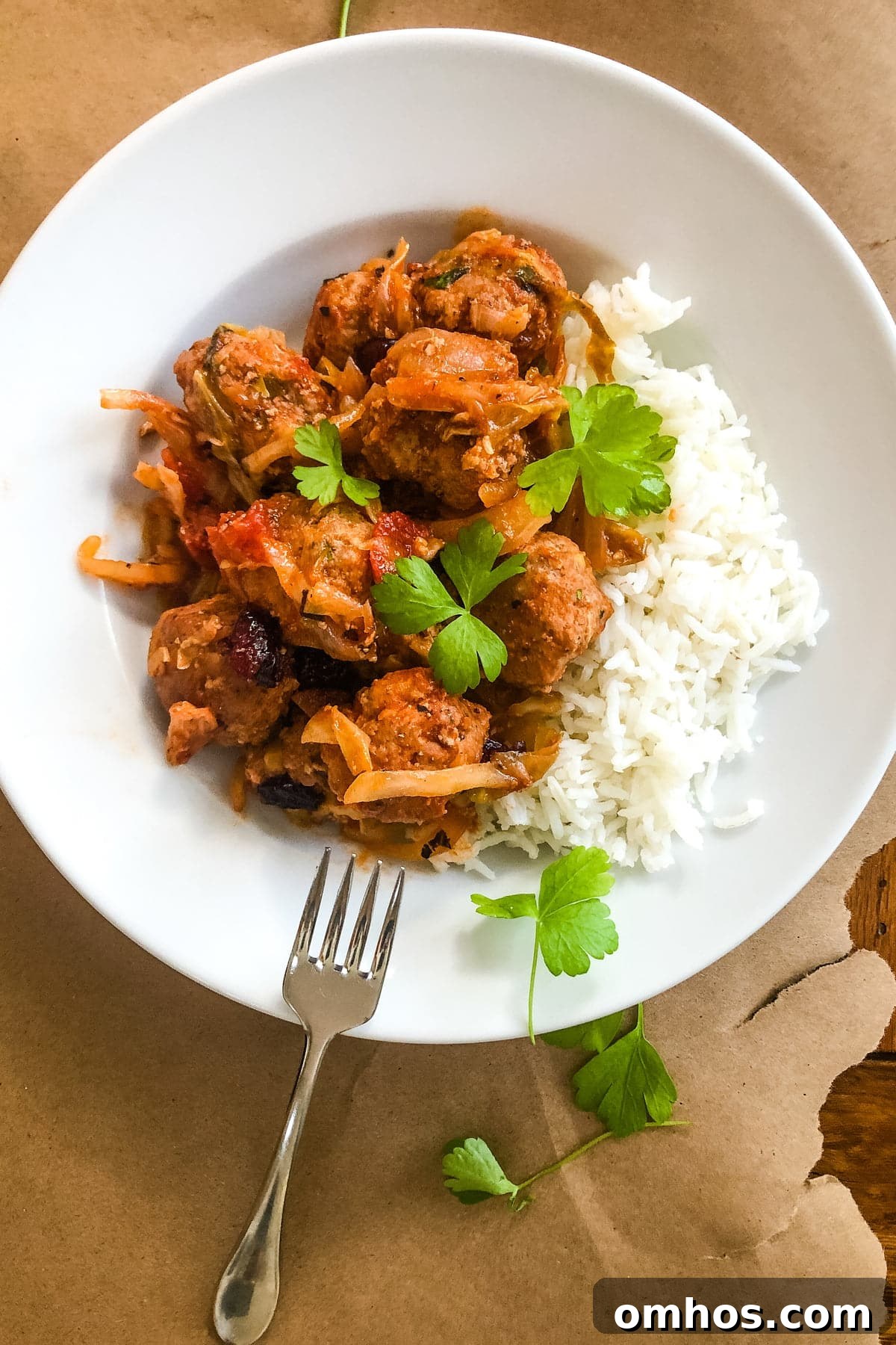 a bowl of cabbage roll meatballs over rice