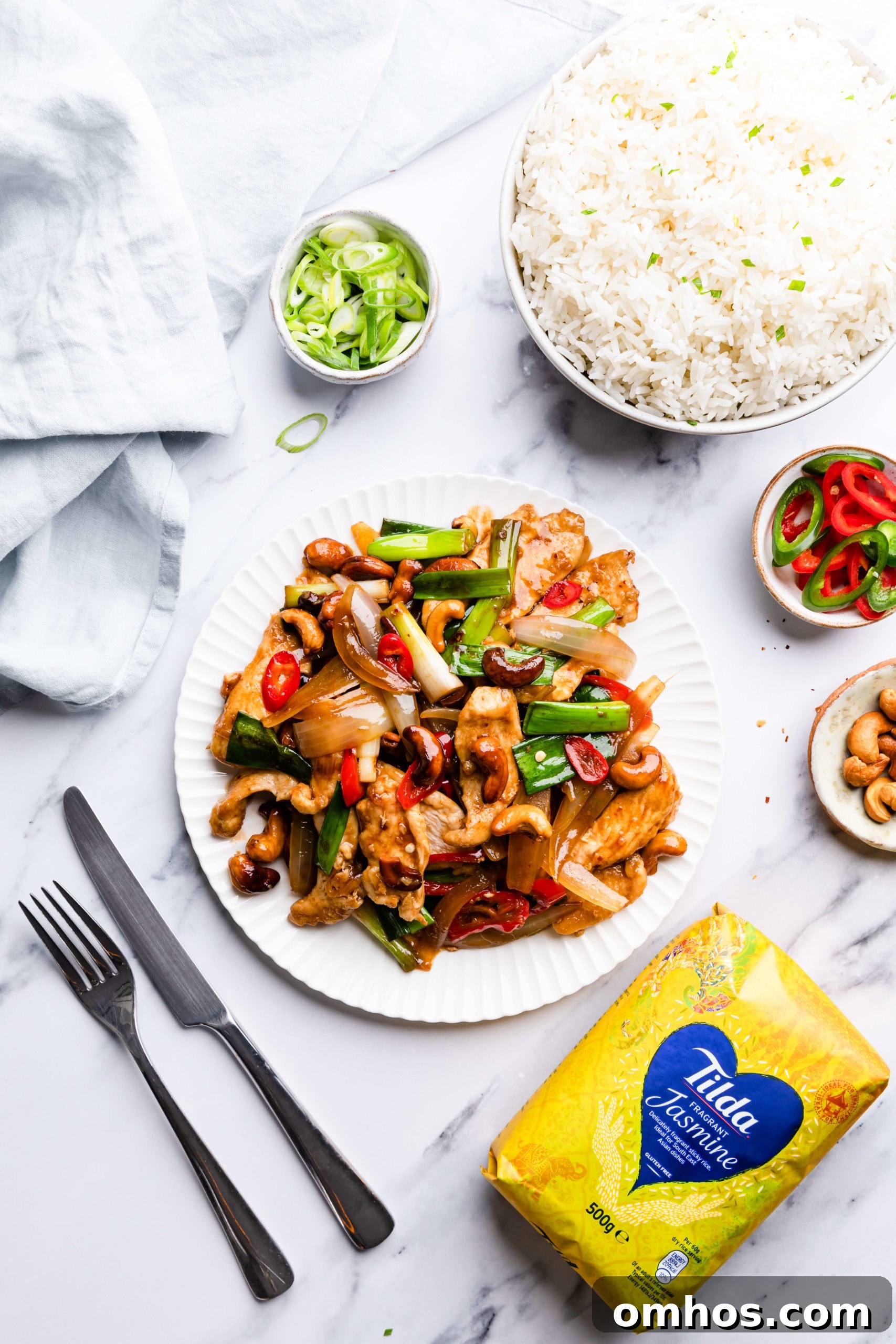 overhead view of cashew chicken and some side dishes around it
