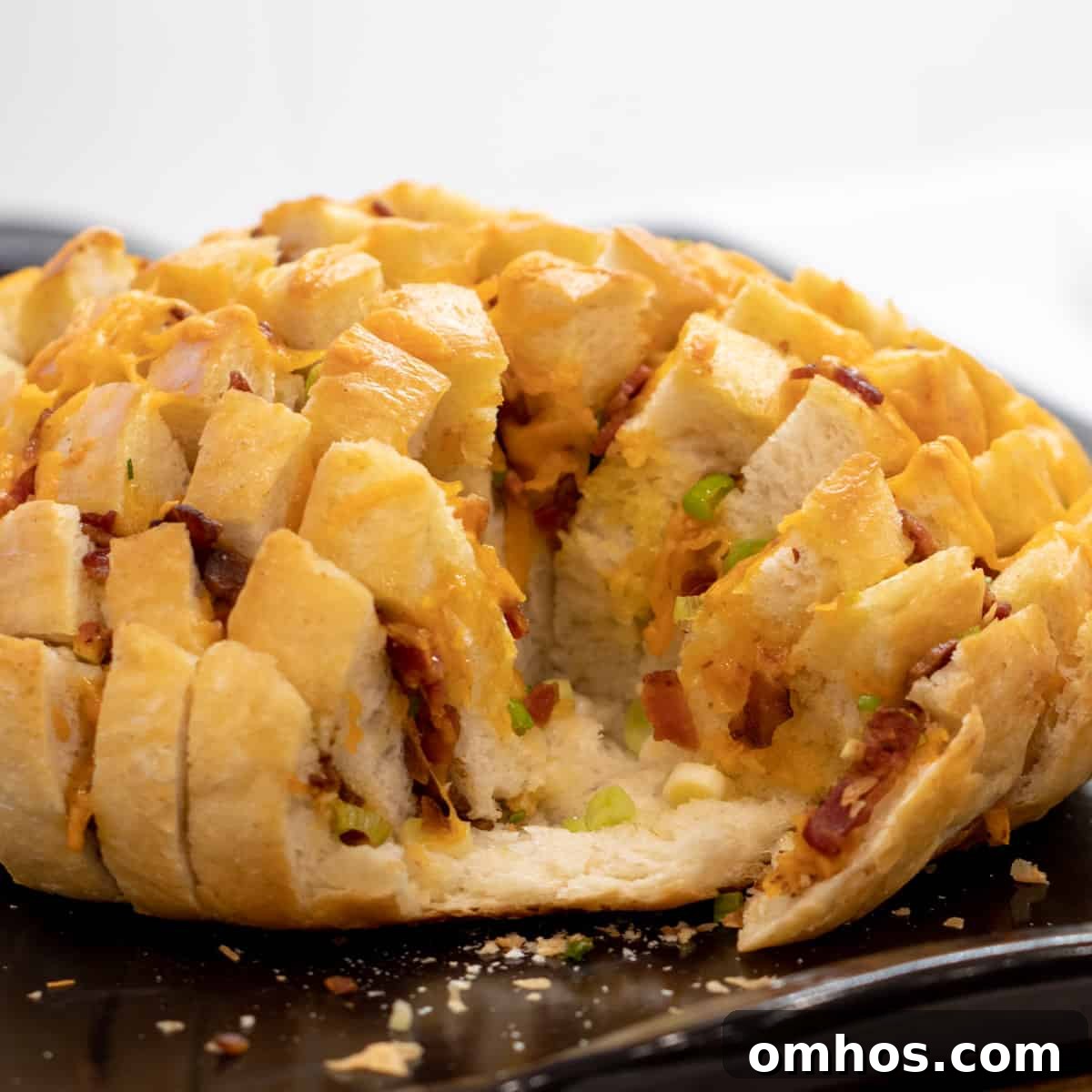 Pull apart bread on a baking stone with about one quarter of the bread gone.