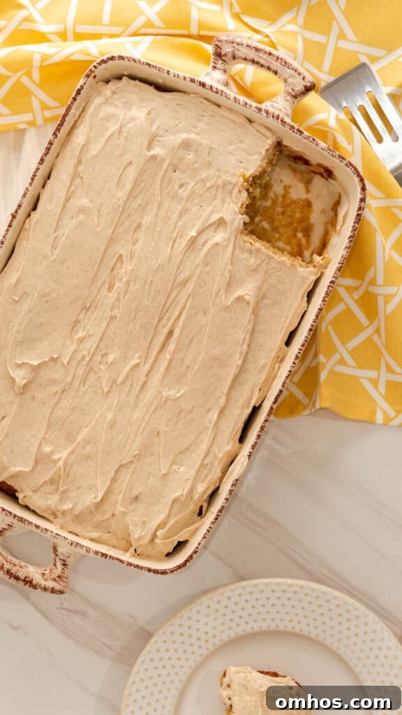 Moist Banana Cake Recipe with Cream Cheese Frosting 2 A slice of banana cake cut out of 13x9 baking dish frosted with cream cheese frosting.