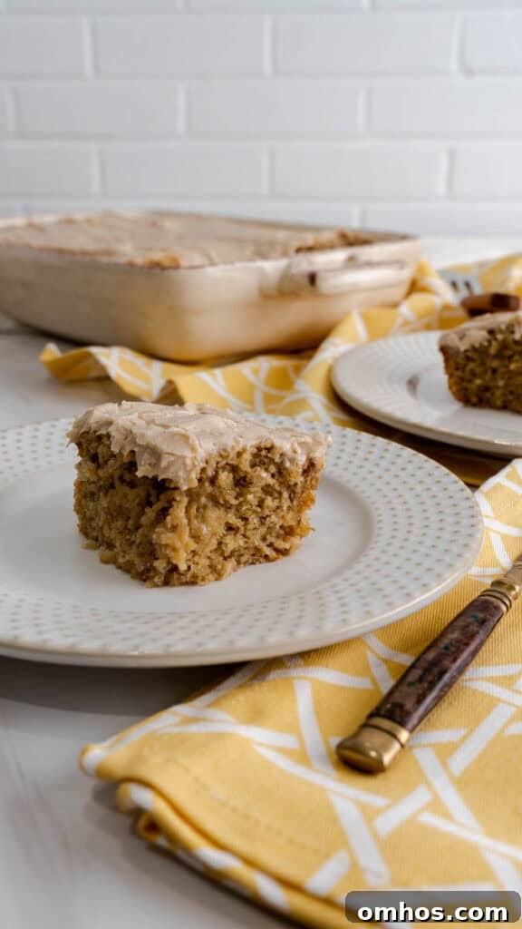 Moist Banana Cake Recipe with Cream Cheese Frosting 4 A slice of sheet cake on a beige plate next to a decorative yellow napkin.