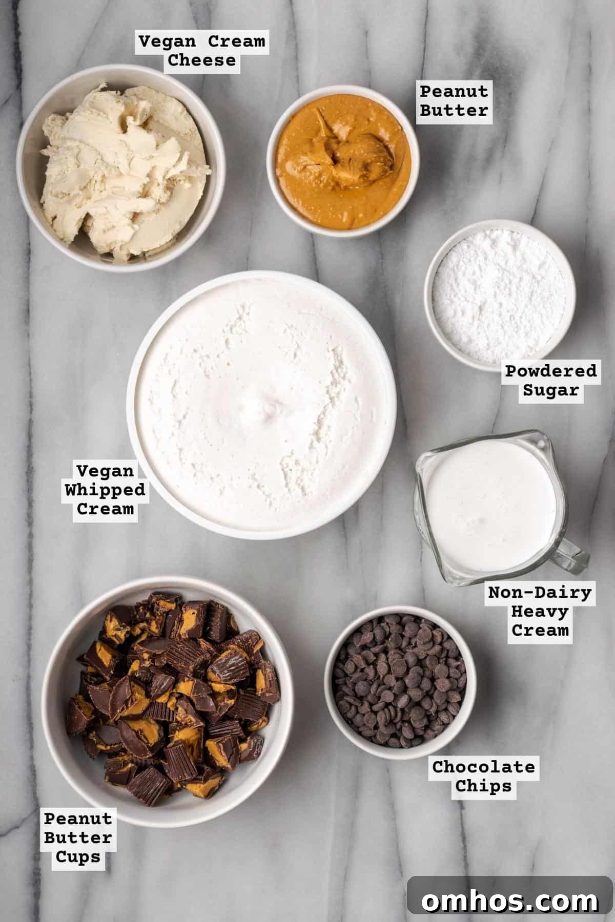 Ingredients for a gluten free peanut butter pie sitting on a marble countertop.