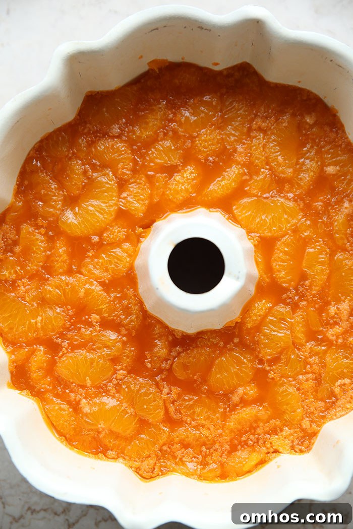 A bundt pan filled with mandarin oranges and orange Jello.