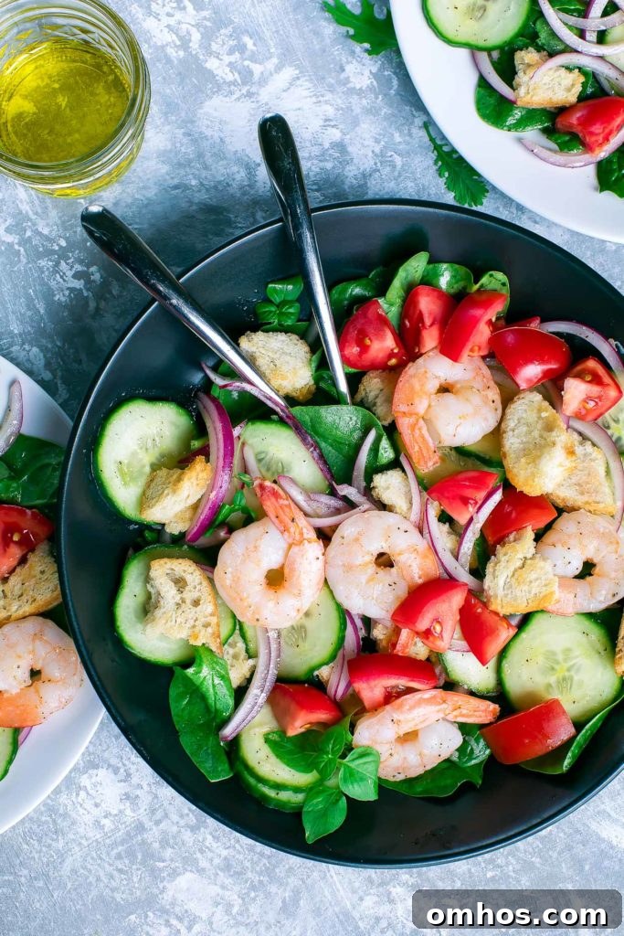 Shrimp Spinach Salad with tomatoes, cucumber, basil, red onion, and croutons