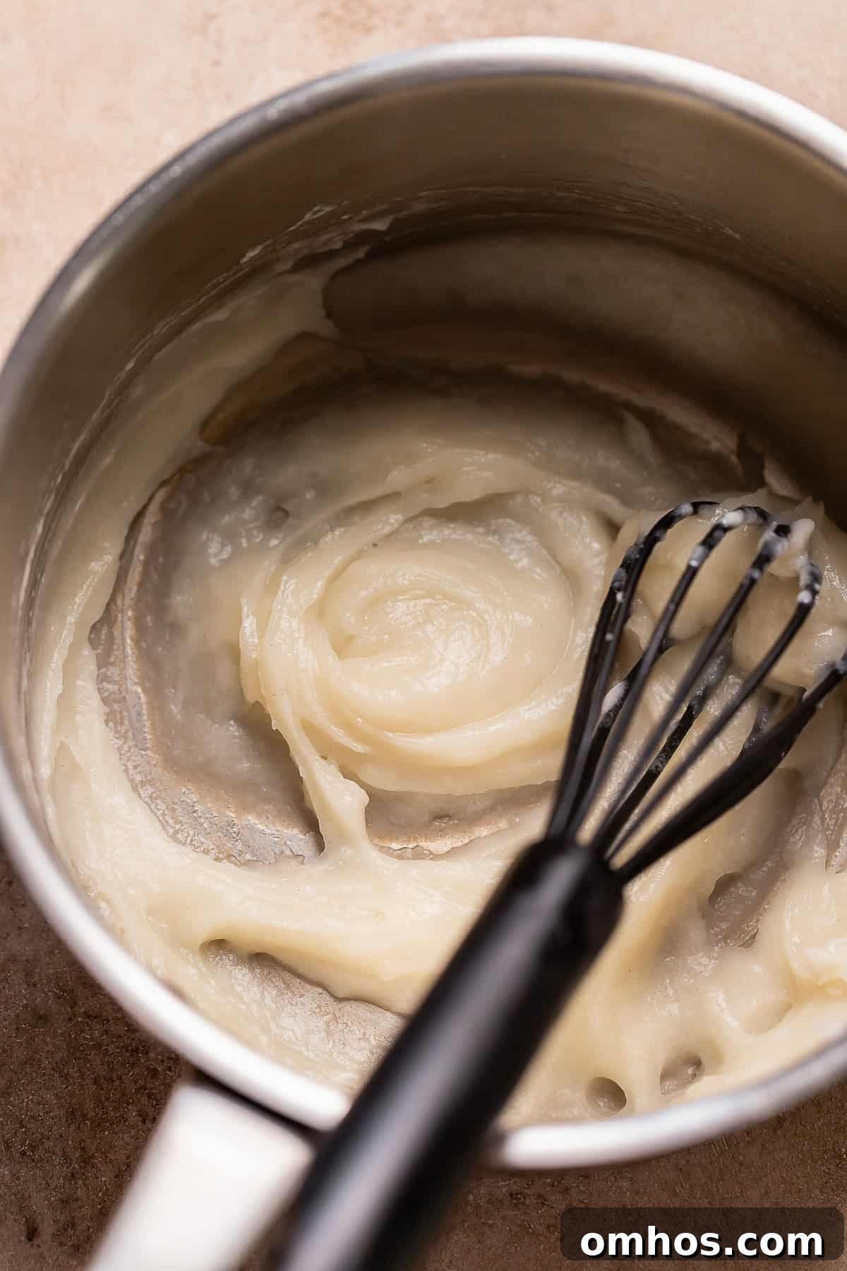 Cooked tangzhong roux in a pot being whisked.