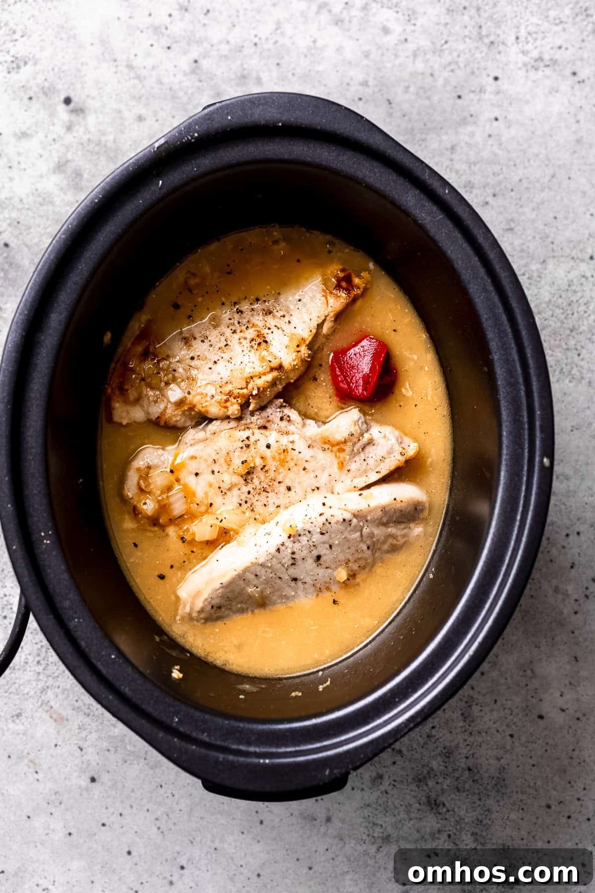 Slow cooker pork chops ingredients in the crock pot.