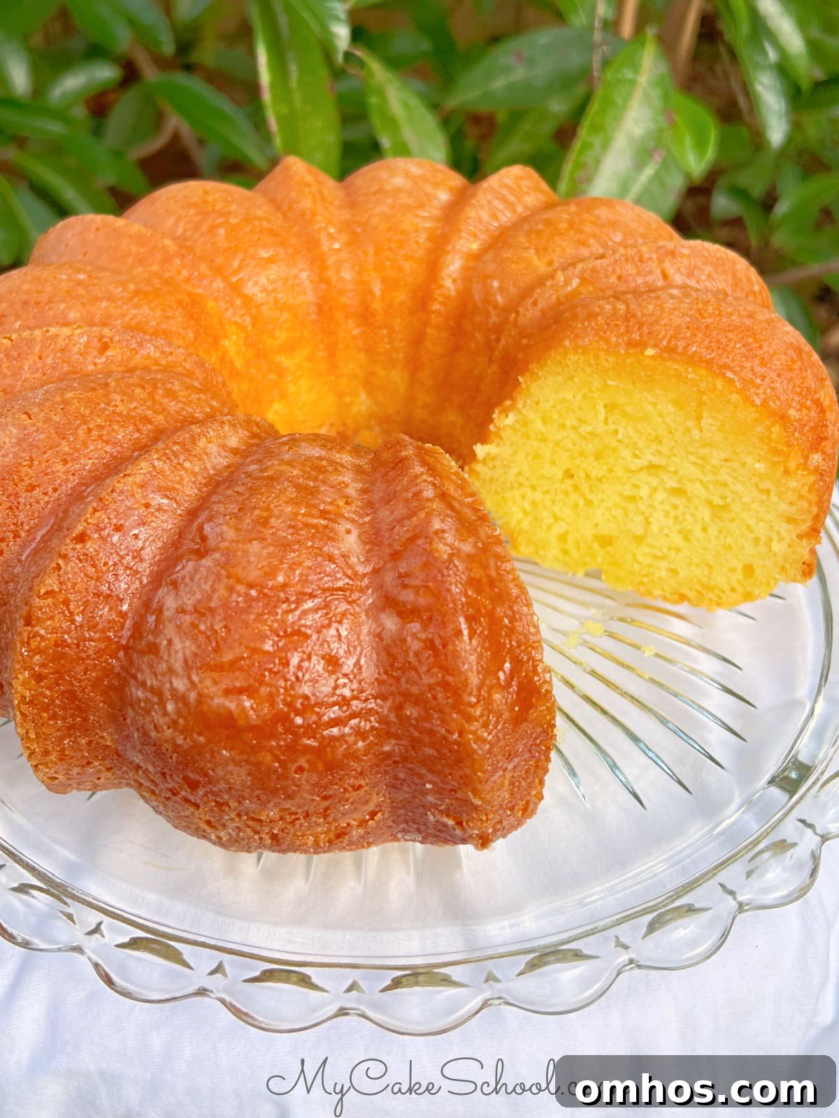 Moist Limoncello Bundt Cake with Lemon Glaze 2 Sliced Limoncello Bundt Cake on a cake pedestal.