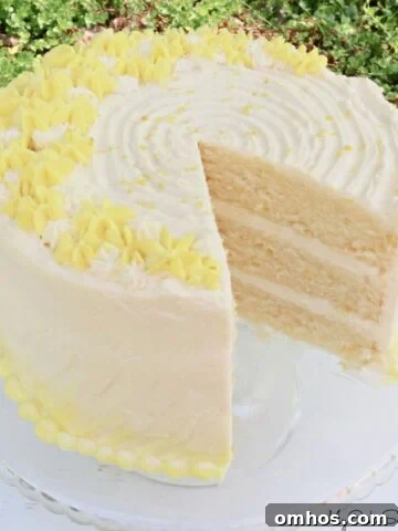 Moist Limoncello Bundt Cake with Lemon Glaze 8 Lemon Buttermilk Cake, sliced, on a glass pedestal.