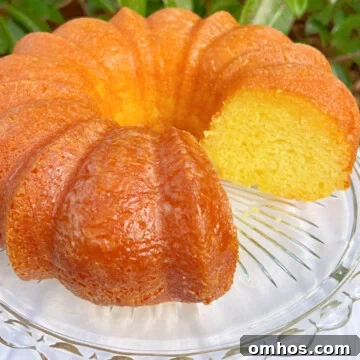 Moist Limoncello Bundt Cake with Lemon Glaze 9 Sliced Limoncello Bundt Cake on a cake pedestal.