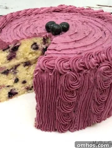 Moist Limoncello Bundt Cake with Lemon Glaze 5 Lemon Blueberry Cake, sliced, on a cake pedestal.