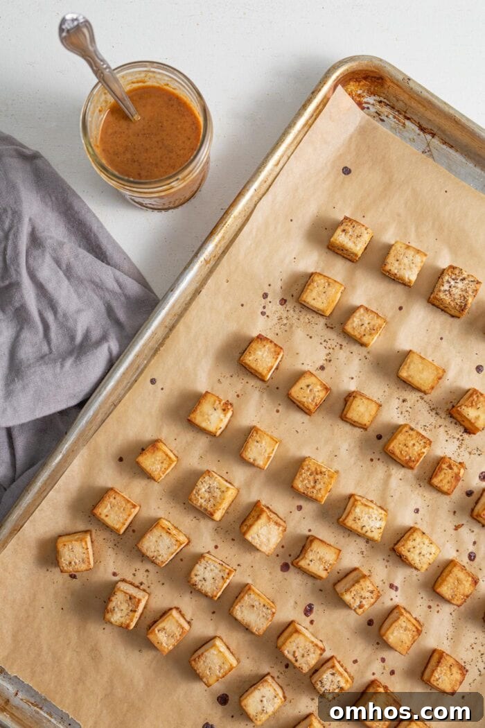 Baked tofu cubes on a tray.