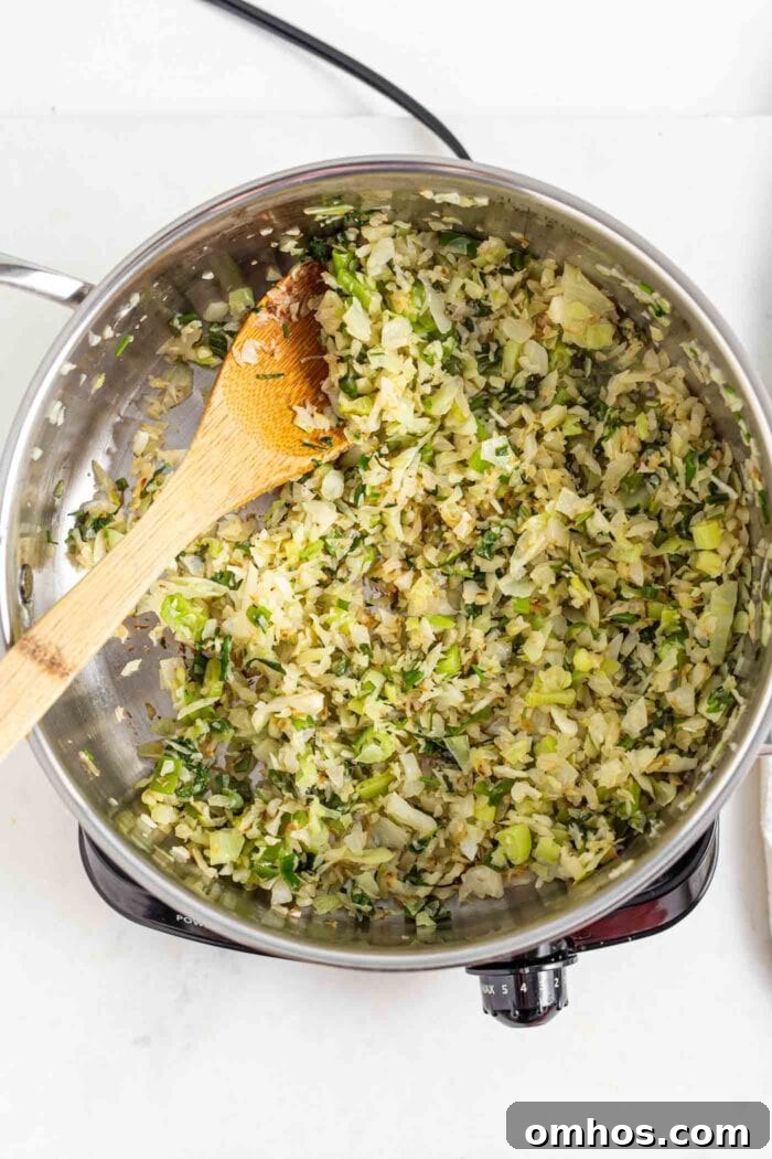 Sautéed cabbage, onion and cilantro in a skillet.