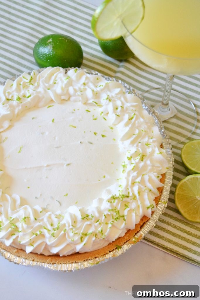 No-Bake Margarita Pie Recipe with Tequila-Lime Filling 2 a beautiful margarita pie with limes around it