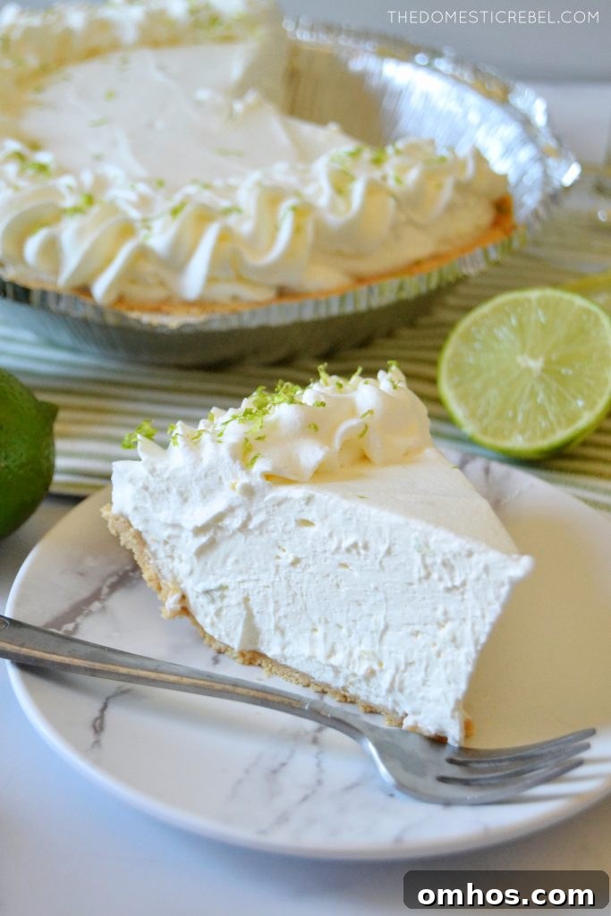 No-Bake Margarita Pie Recipe with Tequila-Lime Filling 3 a piece of margarita pie on a white plate with a whole pie in the background