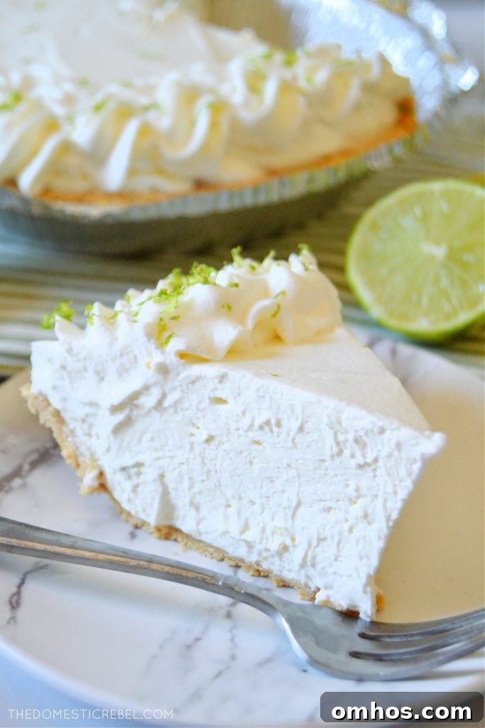 No-Bake Margarita Pie Recipe with Tequila-Lime Filling 4 a piece of margarita pie on a white plate with a silver fork