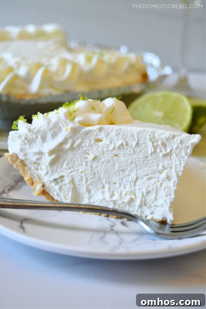 No-Bake Margarita Pie Recipe with Tequila-Lime Filling 5 sideways shot of a piece of margarita pie on a marble plate
