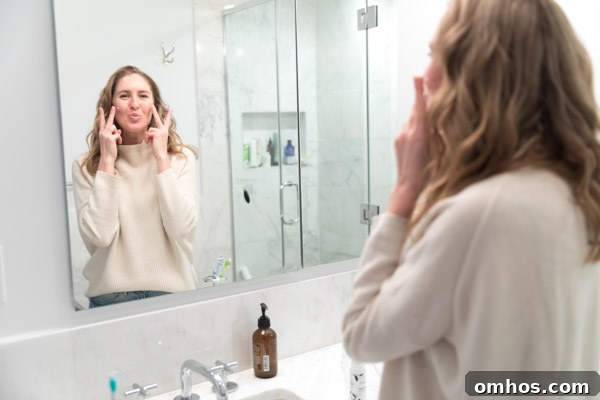 Natural Perioral Dermatitis Remedies Dermatologists Don't Share 8 The author Phoebe Lapine making peace sign with her hands in the bathroom mirror