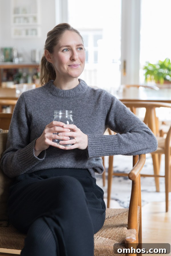 Natural Perioral Dermatitis Remedies Dermatologists Don't Share 9 The author Phoebe Lapine sitting in a chair with a glass of water