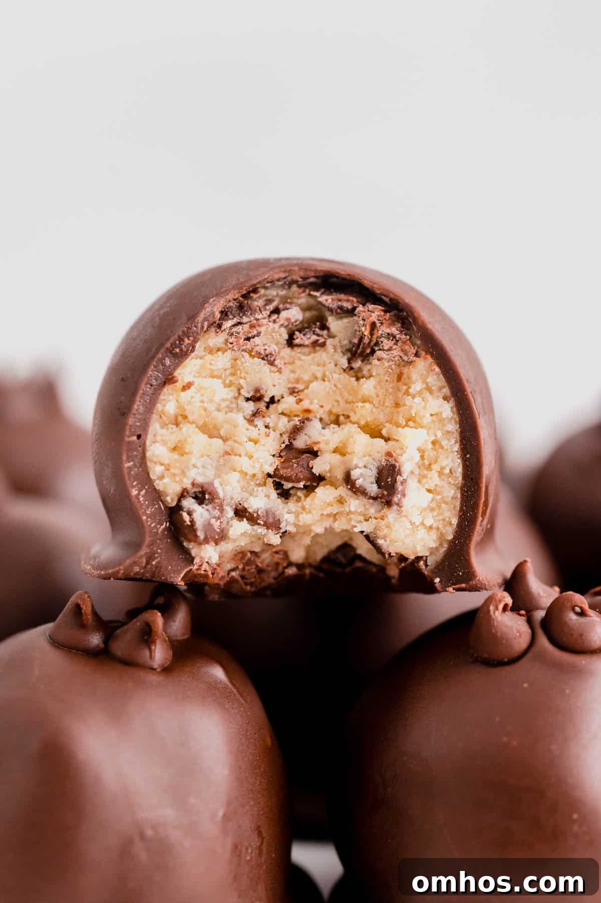No-Bake Chocolate Chip Cookie Dough Truffles 5 a bite taken out of a cookie dough truffle