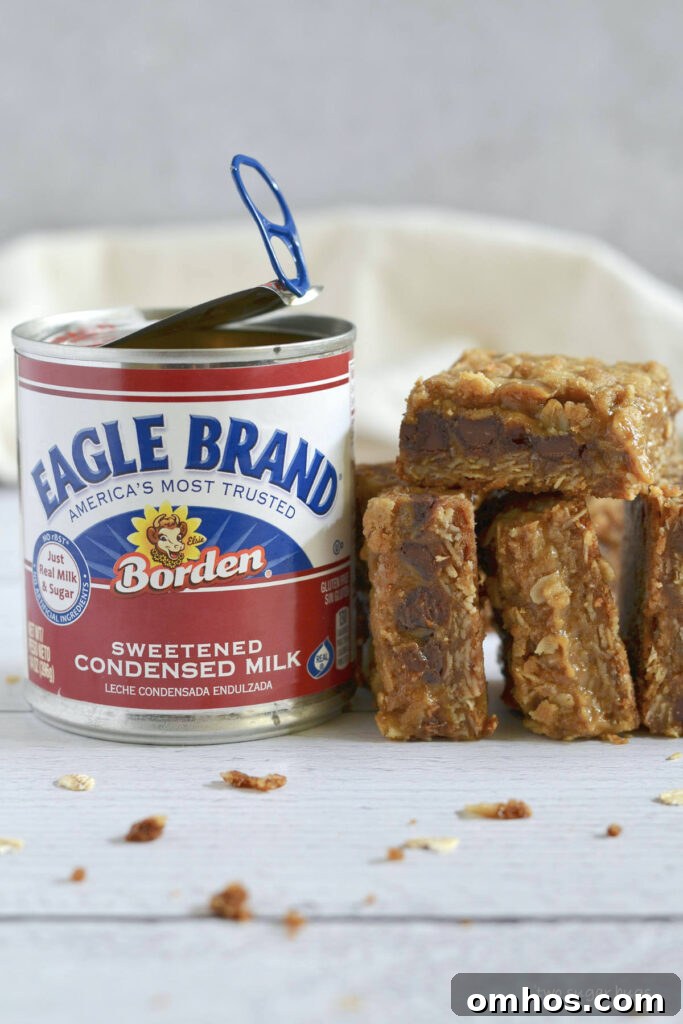pumpkin caramel bars stacked next to an Eagle Brand can