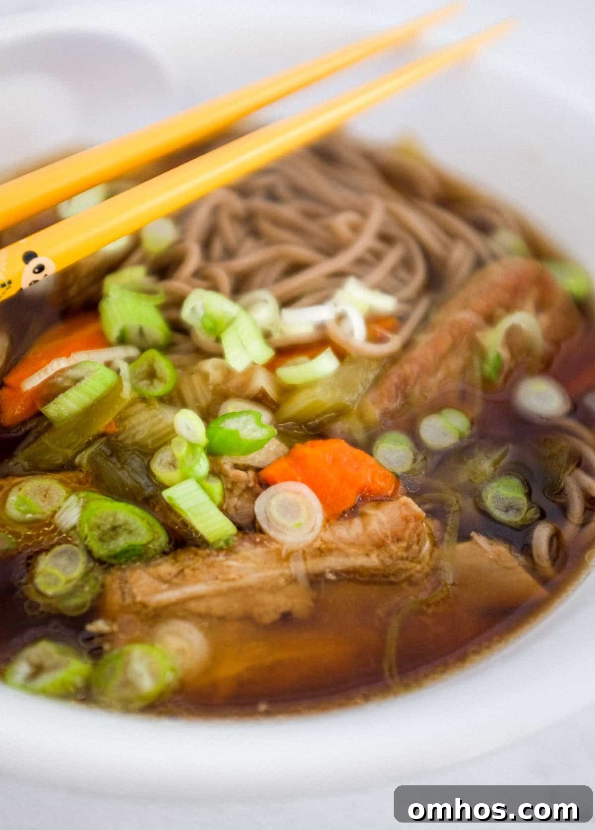 A bowl of pork rib soup with soba noodles