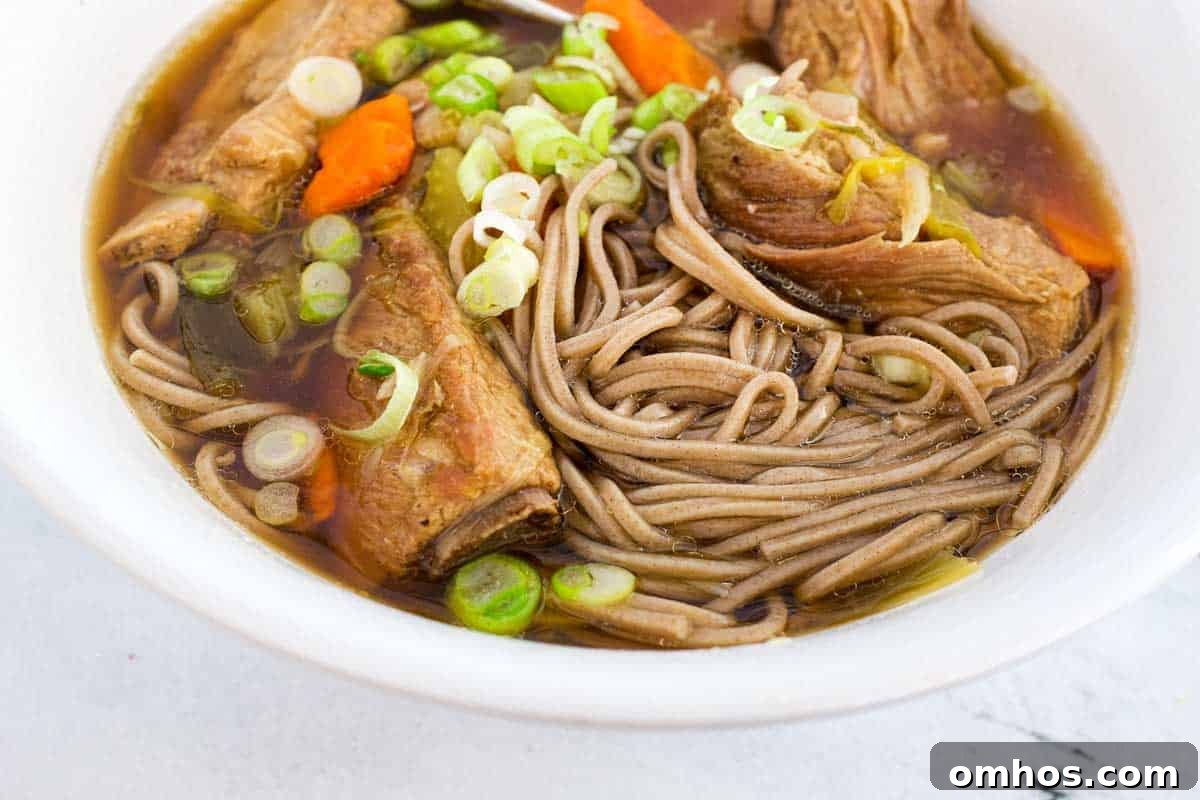 A bowl of pork rib soup with soba noodles