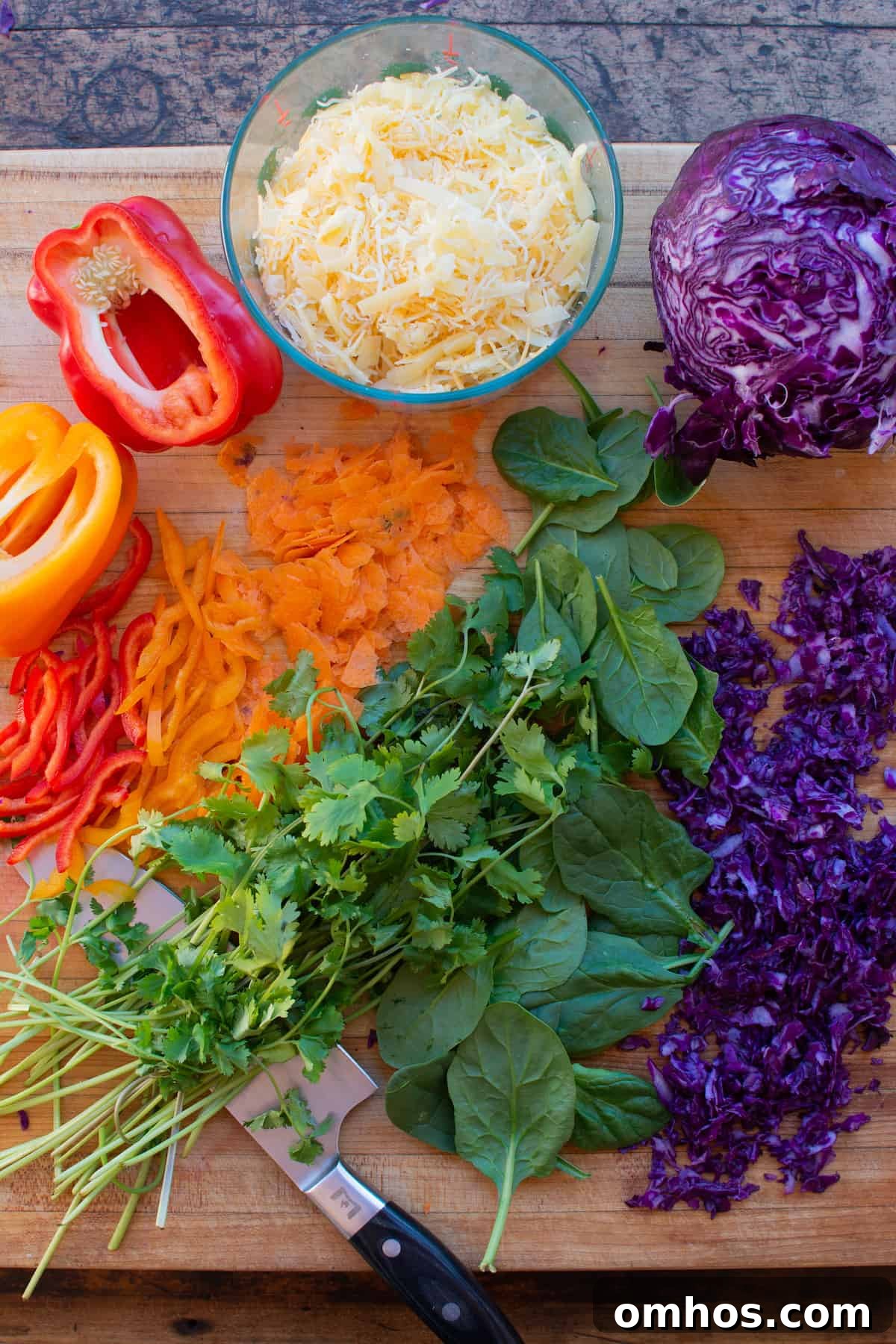 How to Make a Rainbow Vegetable Quesadilla 3 Overhead image of ingredients needed to make veggie quesadillas. Chopped red bell pepper, orange bell peppers, carrots, cilantro, and spinach.