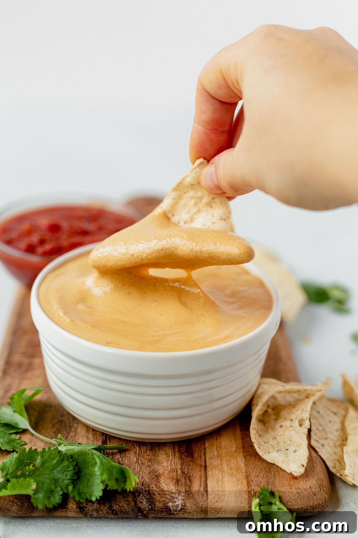 chip dipped into vegan cashew queso