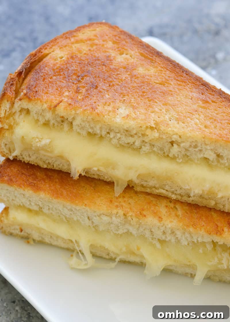 Sliced air fryer grilled cheese with melted cheese pull