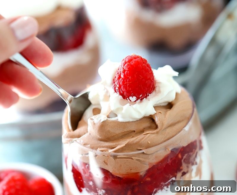 Someone eating a chocolate raspberry trifle
