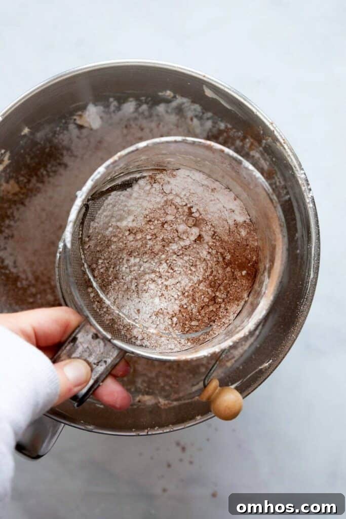 sifting powdered sugar and cocoa powder into creamed vegan butter