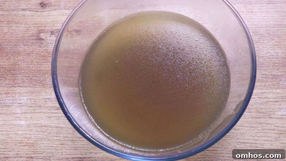 Homemade chicken stock ready to store in bottles.