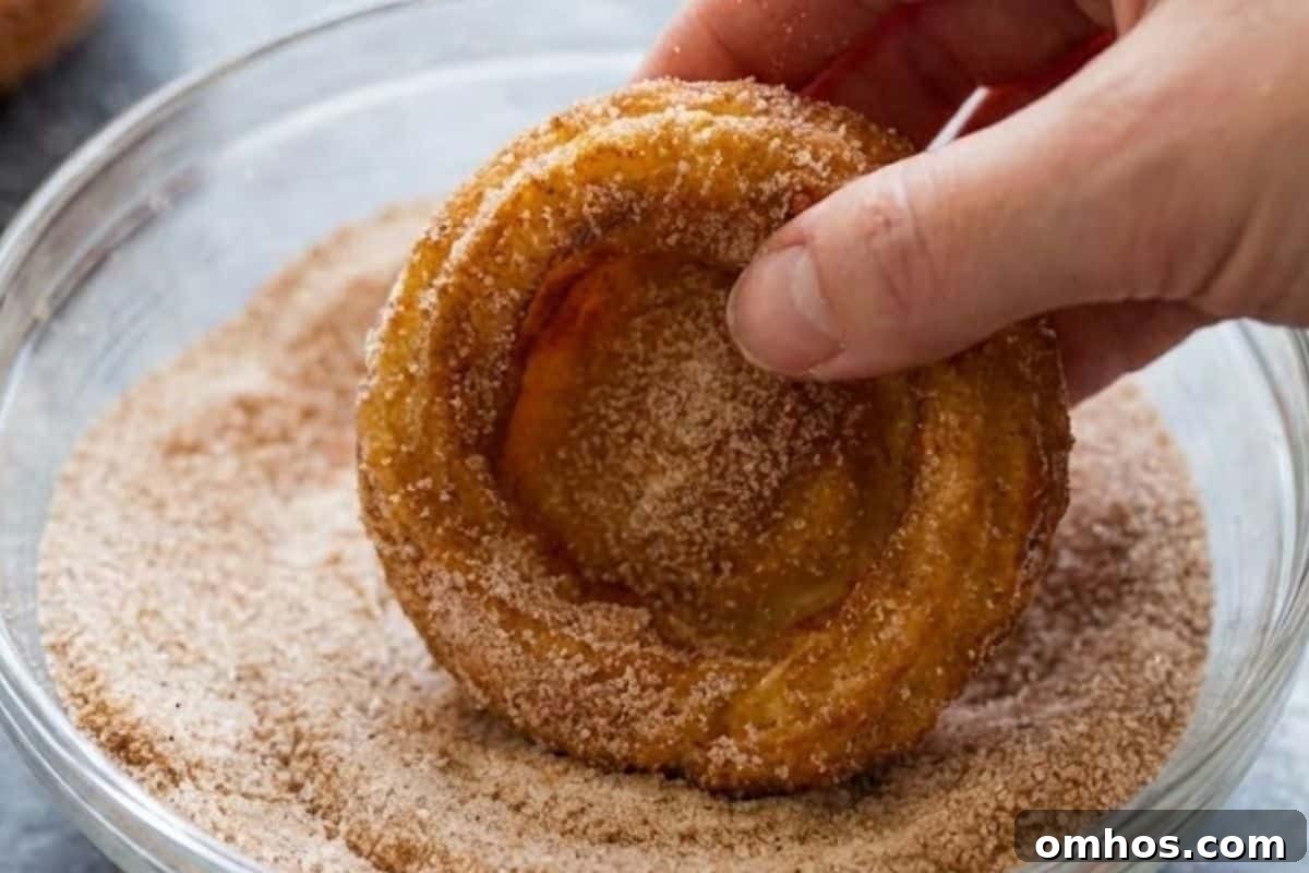 Fill a shallow bowl with cinnamon sugar and coat each churro bowl