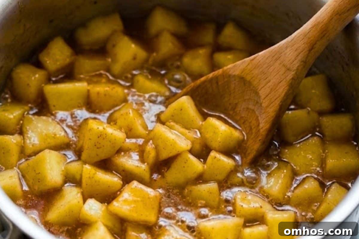 Combine diced apples with lemon juice in a saucepan and set aside. In another pan, whisk cornstarch and water until smooth, then add brown sugar, cinnamon, and nutmeg; bring to a boil, add apples, cover, and simmer 8–10 minutes 