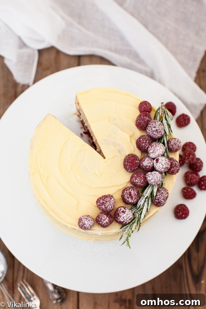 Top down view of the frostbitten raspberry cake with a slice removed