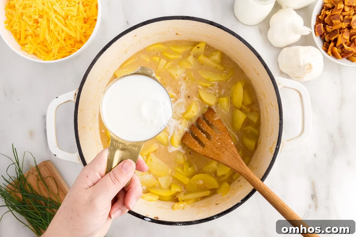 milk added to potato mixture in dutch oven wooden spatula insterted