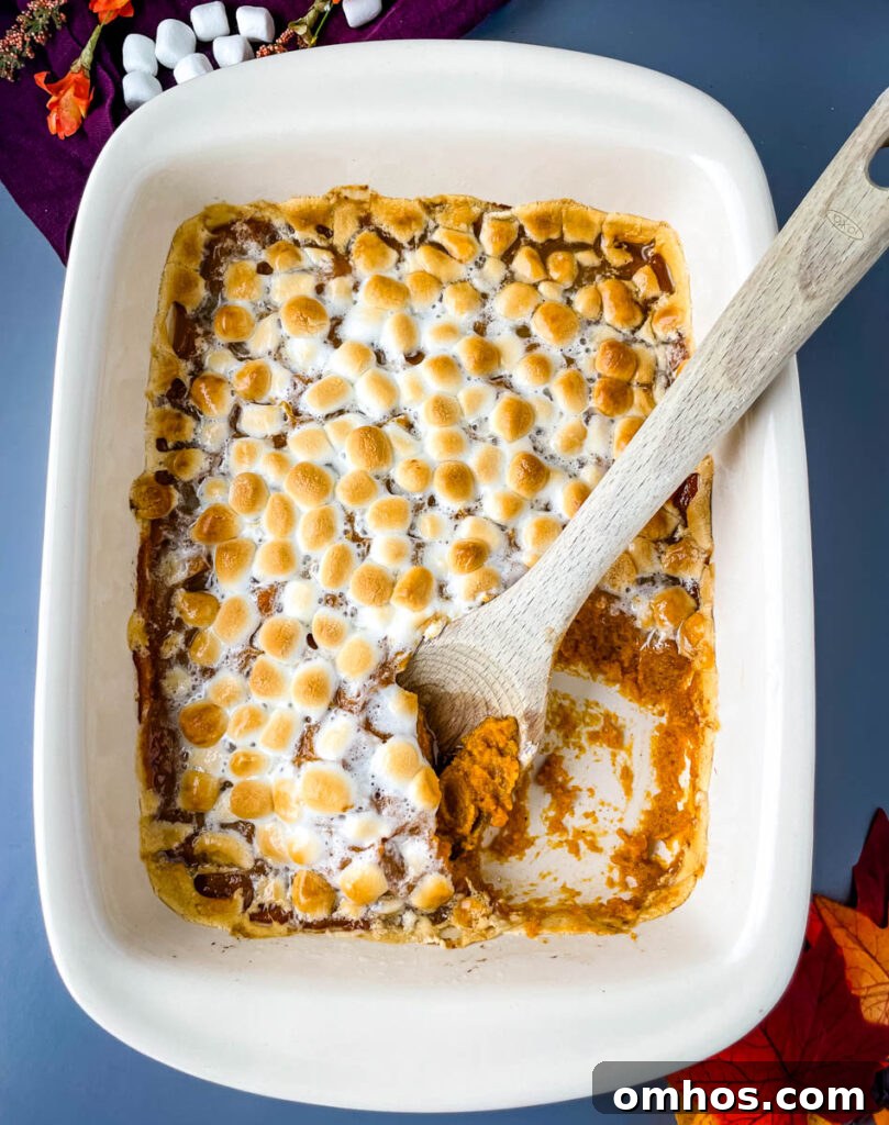 Southern Sweet Potato Casserole with Pecan Streusel 8 spoonful of sweet potato casserole with marshmallows in a red baking dish