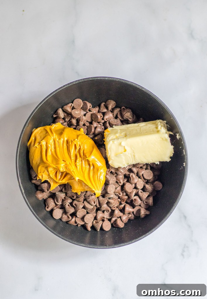 Chocolate chips, peanut butter, and butter in a black bowl