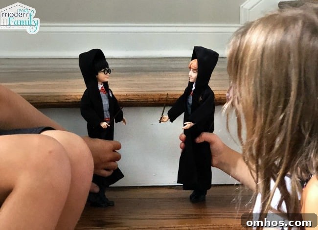 Harry Potter Toys and Gift Ideas for Fans 7 Two children playing with Harry Potter and Hermione Granger figurines.