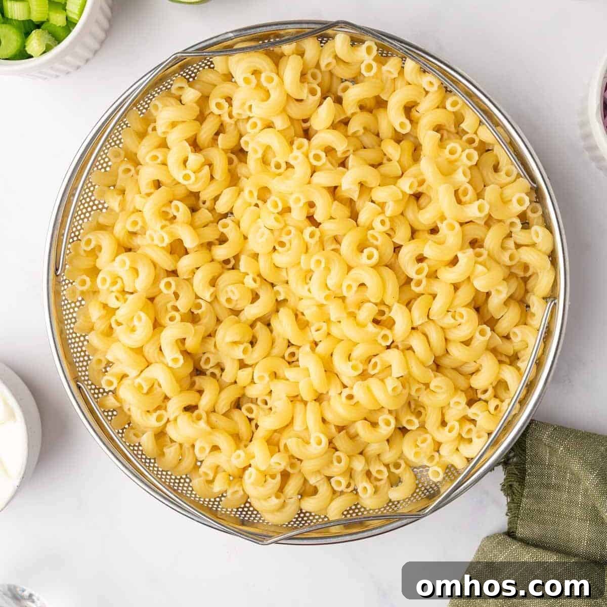 Cooked macaroni in a colander.