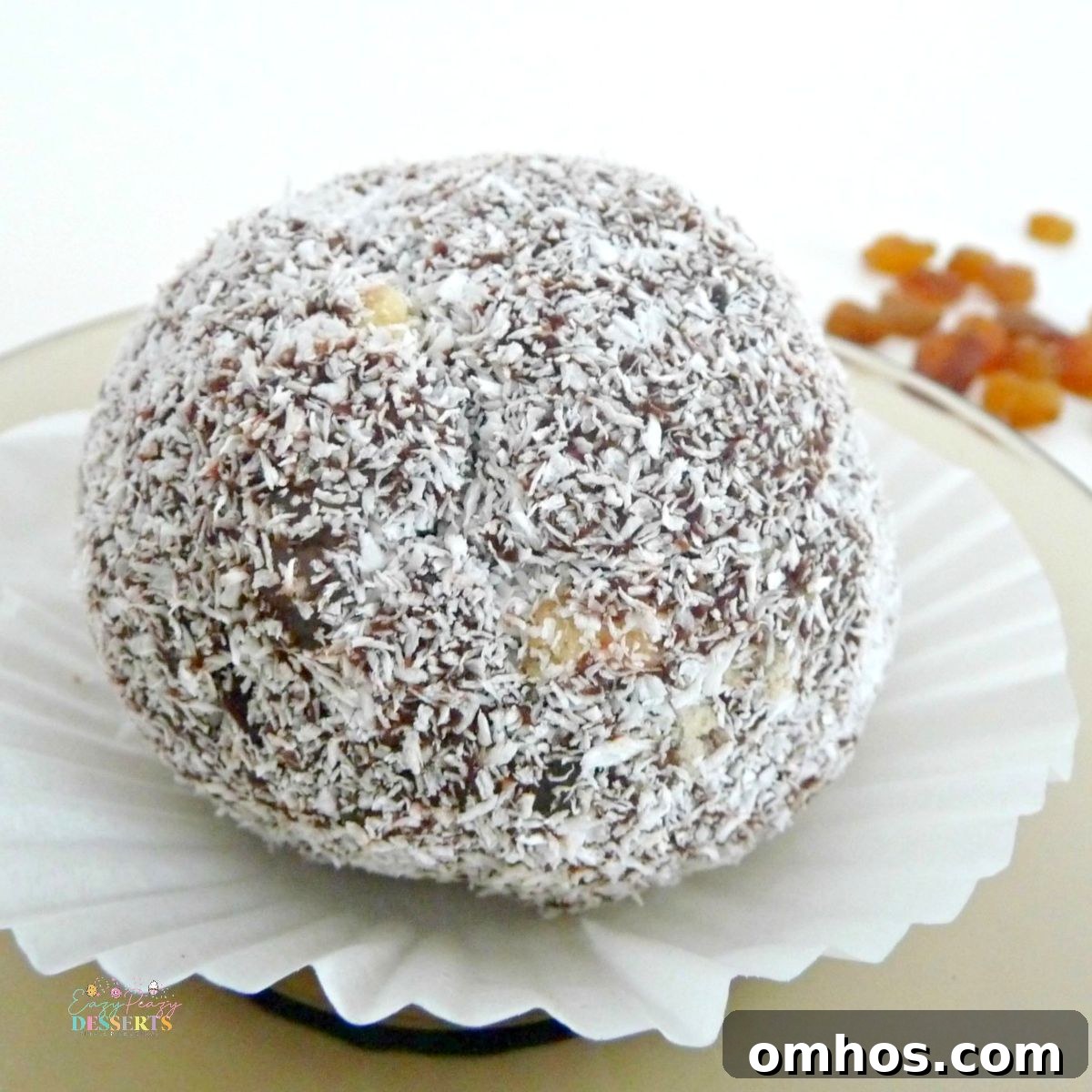 Close up image of a cookie truffle covered in coconut