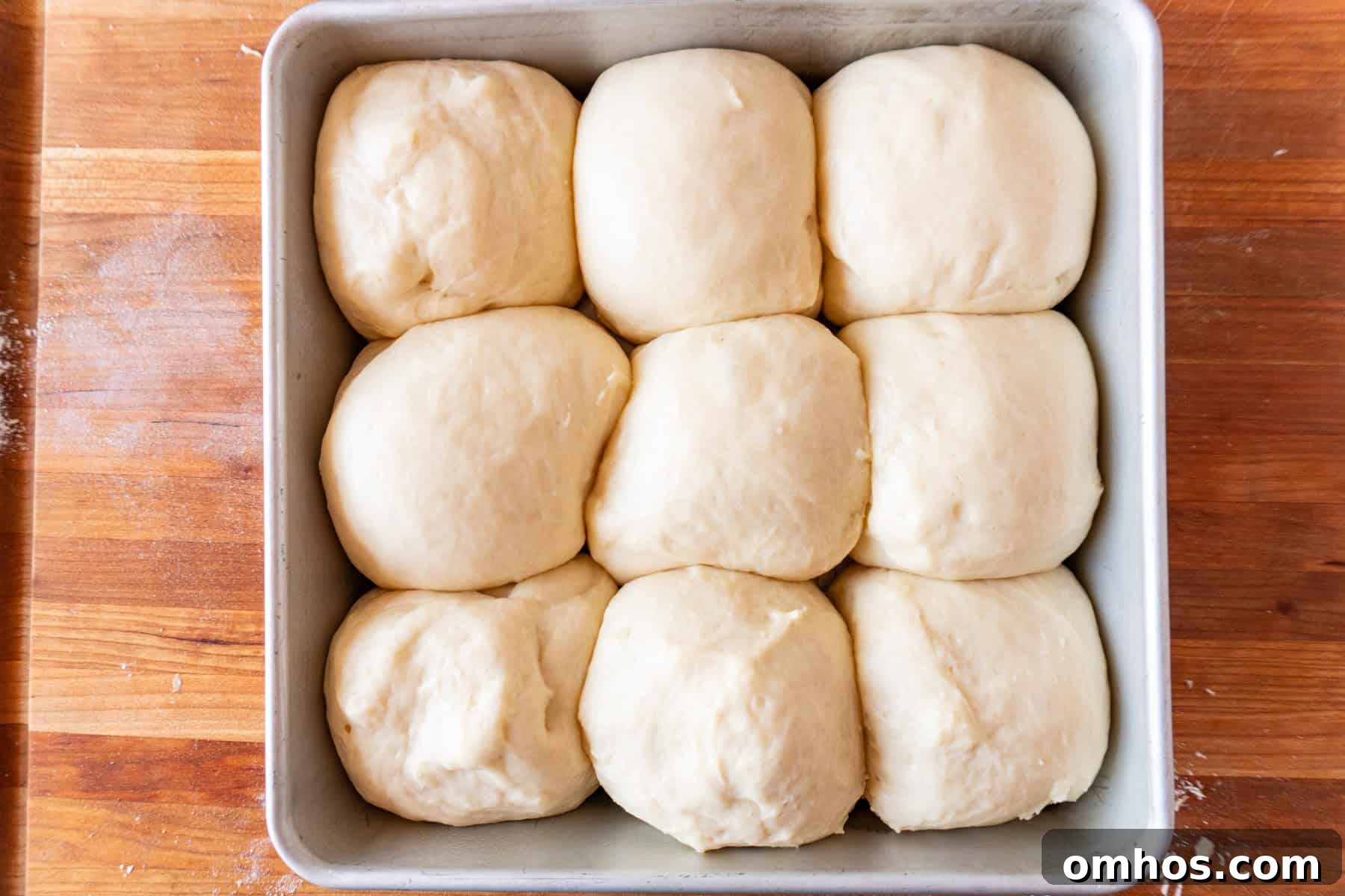 Fluffy Soft Dinner Rolls: Buttery Homemade Recipe 13 bread dough rolls in pan after second rise.