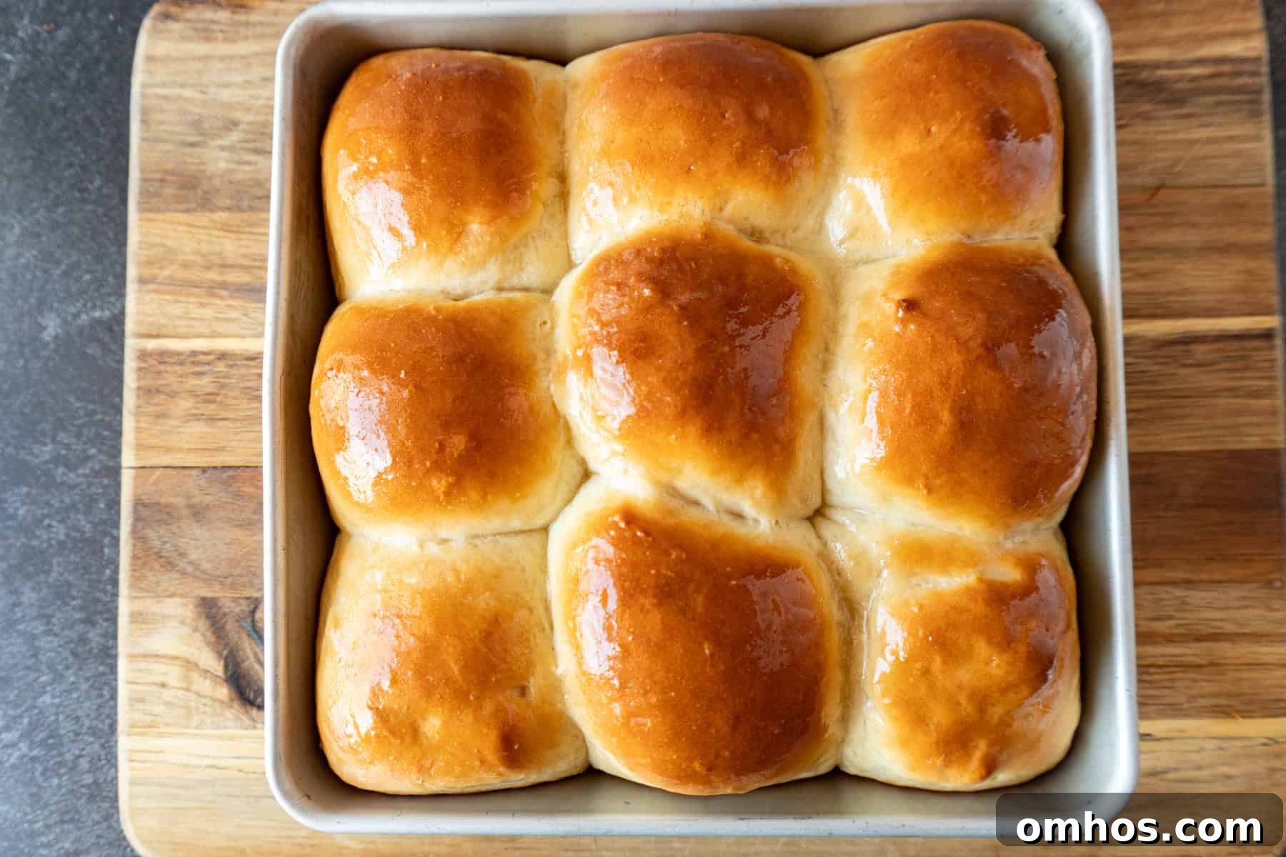 Fluffy Soft Dinner Rolls: Buttery Homemade Recipe 15 baked soft dinner rolls with golden tops and shiny melted butter.